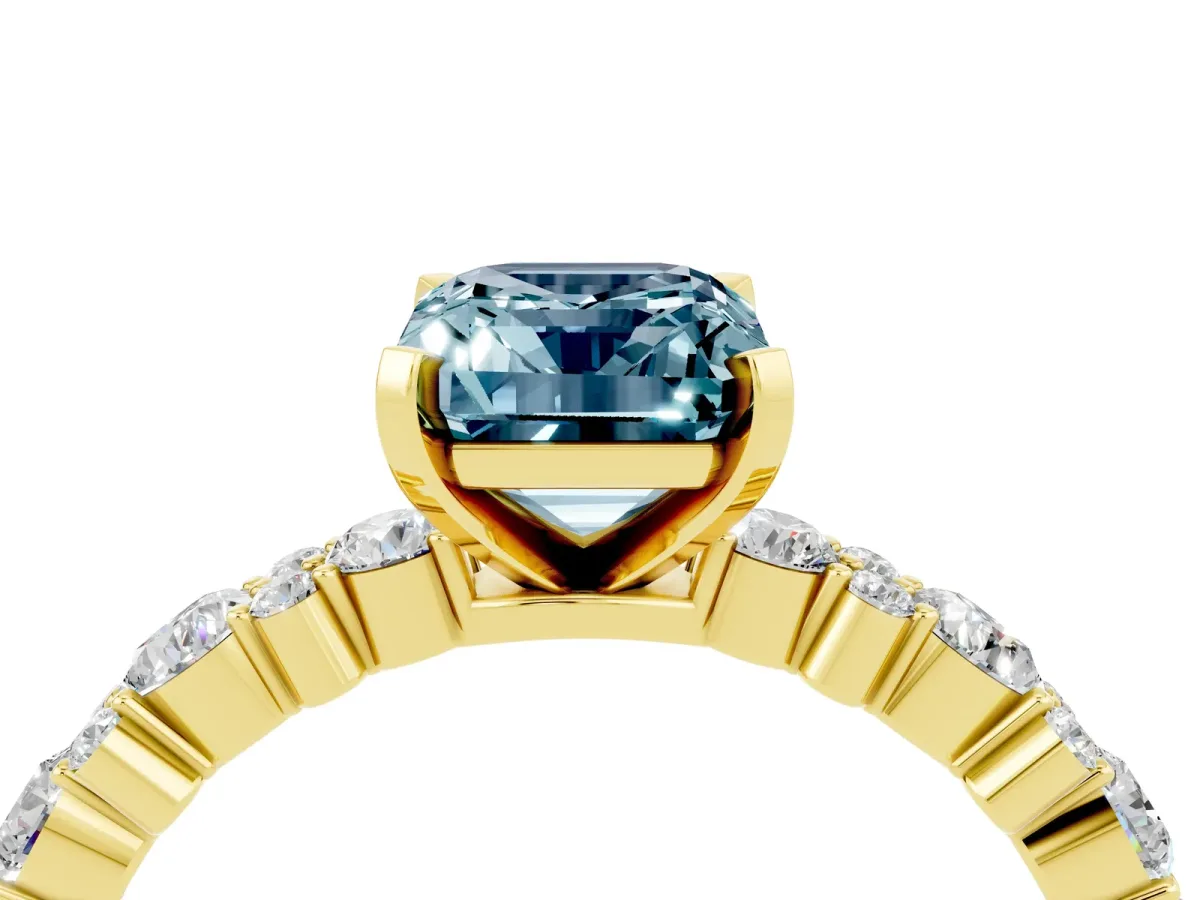 Emerald Cut Aquamarine Side Stone Solitaire Ring with Round and Four-Prong Setting Yellow gold