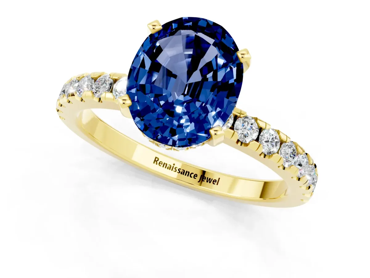 Oval Cut Blue Sapphire Solitaire Ring with Round Pavé Band and Four-Prong Setting Yellow gold