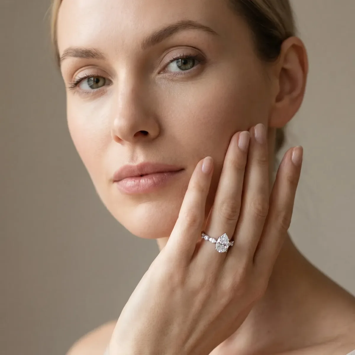 Pear Cut Diamond Ring with Marquise and Round Side Stones and Four-Prong Setting White gold