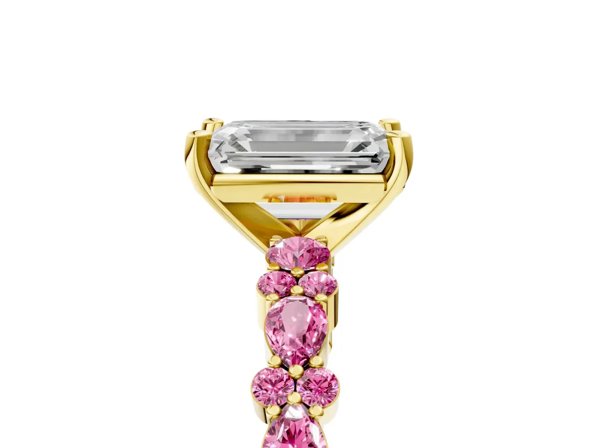 Emerald Cut Diamond Side Stone Solitaire Ring with Round Pink Sapphire and Four-Prong Setting Yellow gold