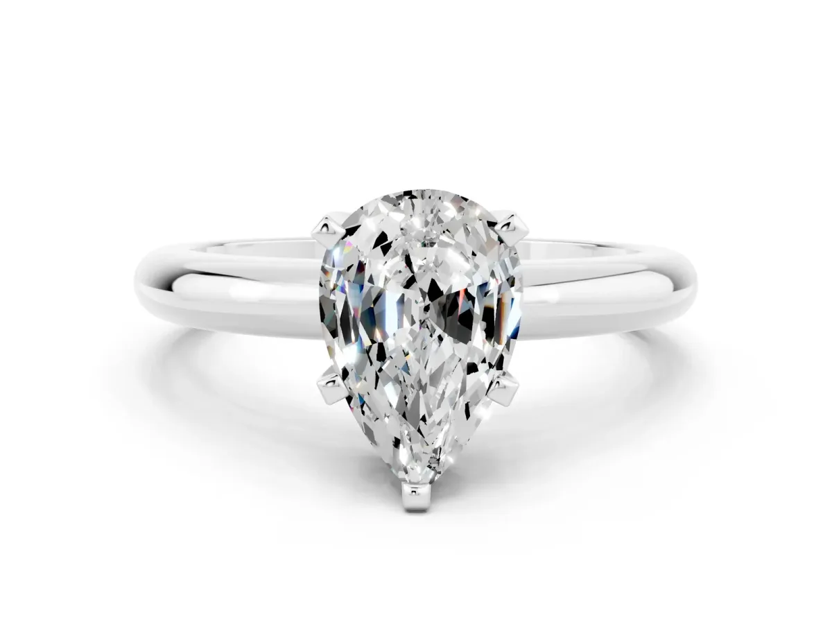 Pear Cut Moissanite Solitaire Engagement Ring with Round Band and Four-Prong Setting Silver