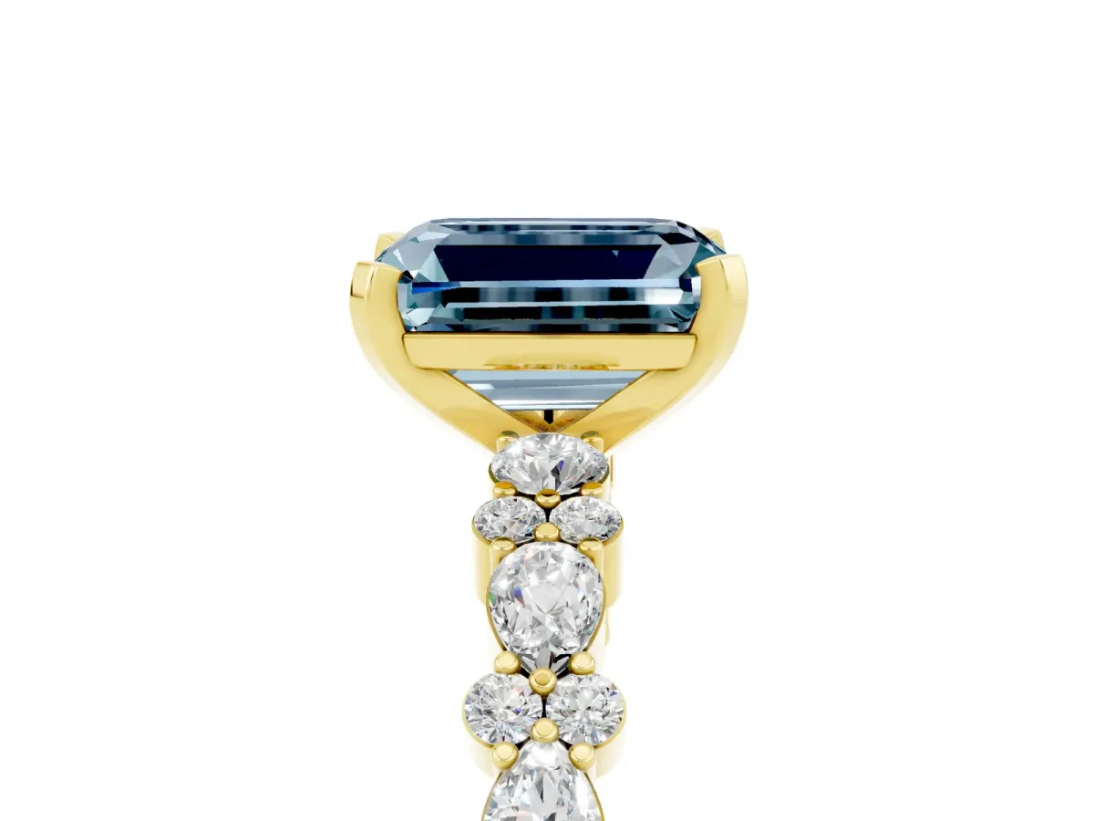 Emerald Cut Aquamarine Side Stone Solitaire Ring with Round and Four-Prong Setting Yellow gold