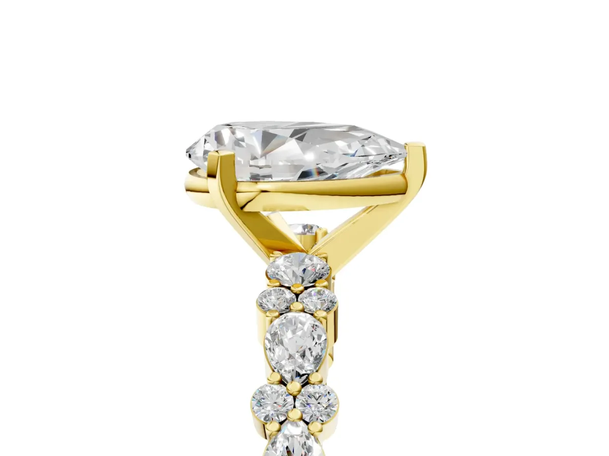 Pear Cut Diamond Side Stone Solitaire Ring with Round and Four-Prong Setting Yellow gold