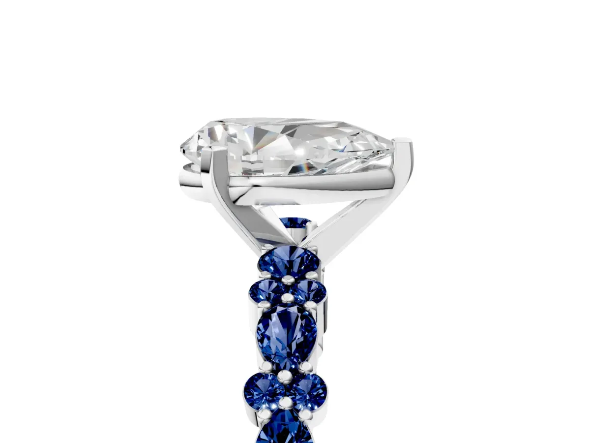Pear Cut Diamond Side Stone Solitaire Ring with Round Blue Sapphire and Four-Prong Setting Platinum
