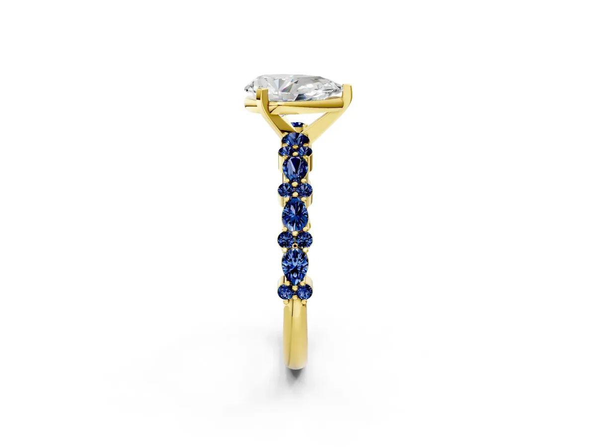 Pear Cut Diamond Side Stone Solitaire Ring with Round Blue Sapphire and Four-Prong Setting Yellow gold