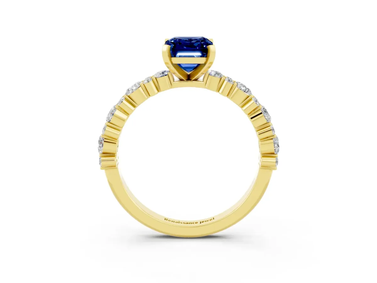 Emerald Cut Blue Sapphire Side Stone Solitaire Ring with Round and Four-Prong Setting Yellow gold