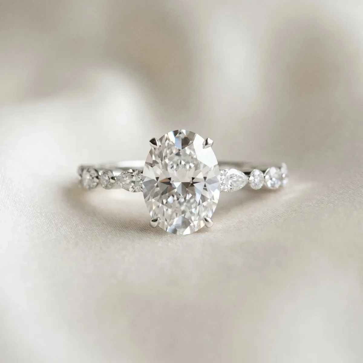 Oval Cut Diamond Ring with Marquise and Round Side Stones and Four-Prong Setting Silver