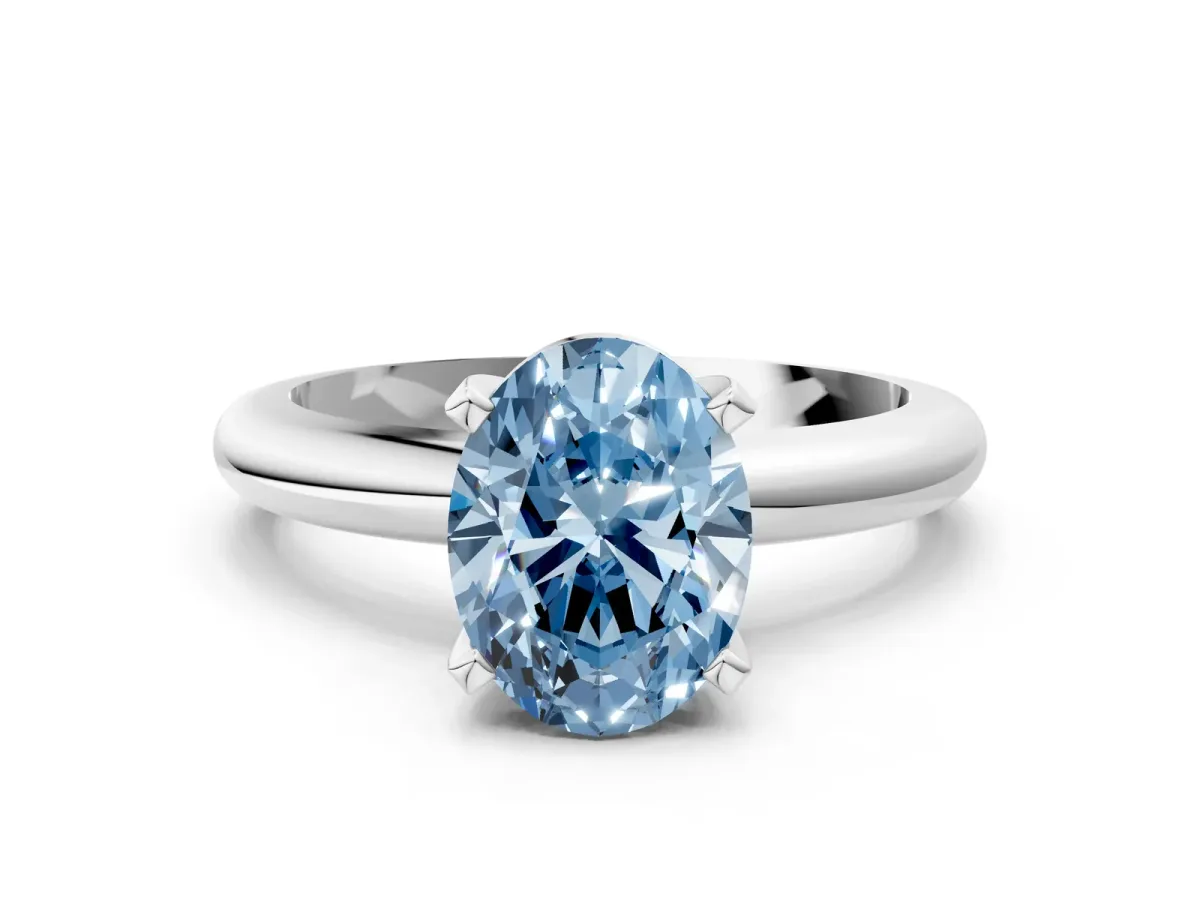 Fancy Blue Oval Cut Diamond Solitaire Engagement Ring with Round Band and Four-Prong Setting White gold