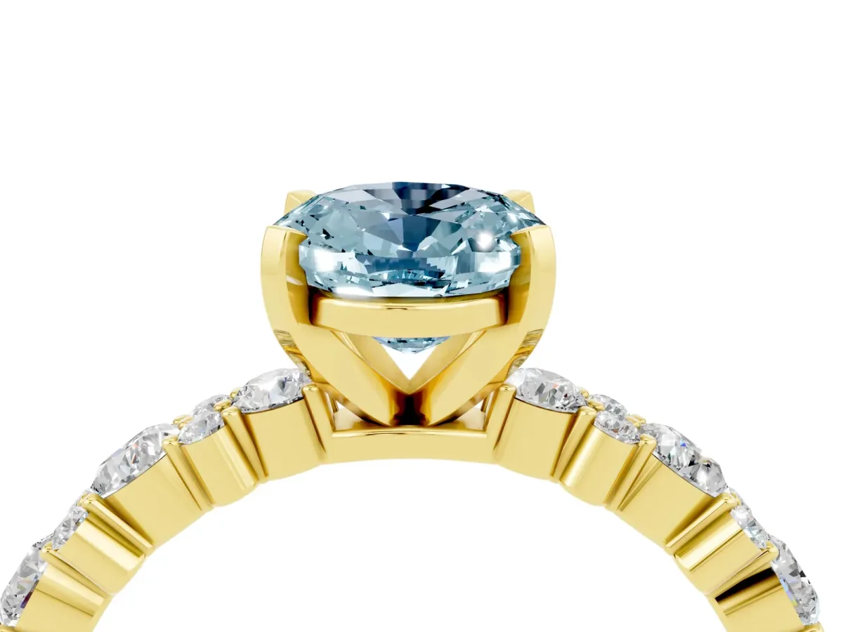 Oval Cut Aquamarine Side Stone Solitaire Ring with Round and Four-Prong Setting Yellow gold