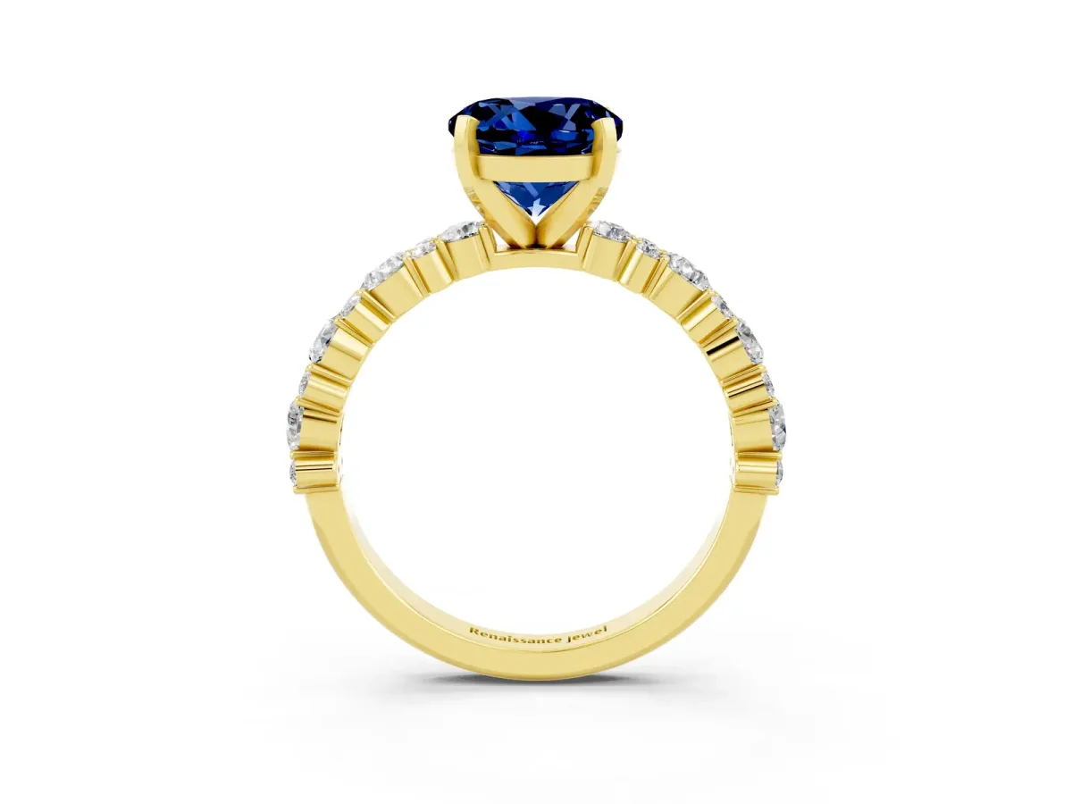 Round Cut Blue Sapphire Side Stone Solitaire Ring with Round and Four-Prong Setting Yellow gold