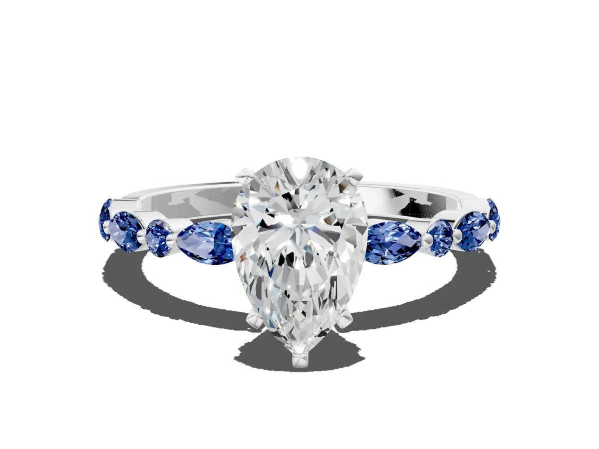 Pear Cut Diamond Ring with Marquise and Round Blue Sapphire Side Stones and Four-Prong Setting Platinum
