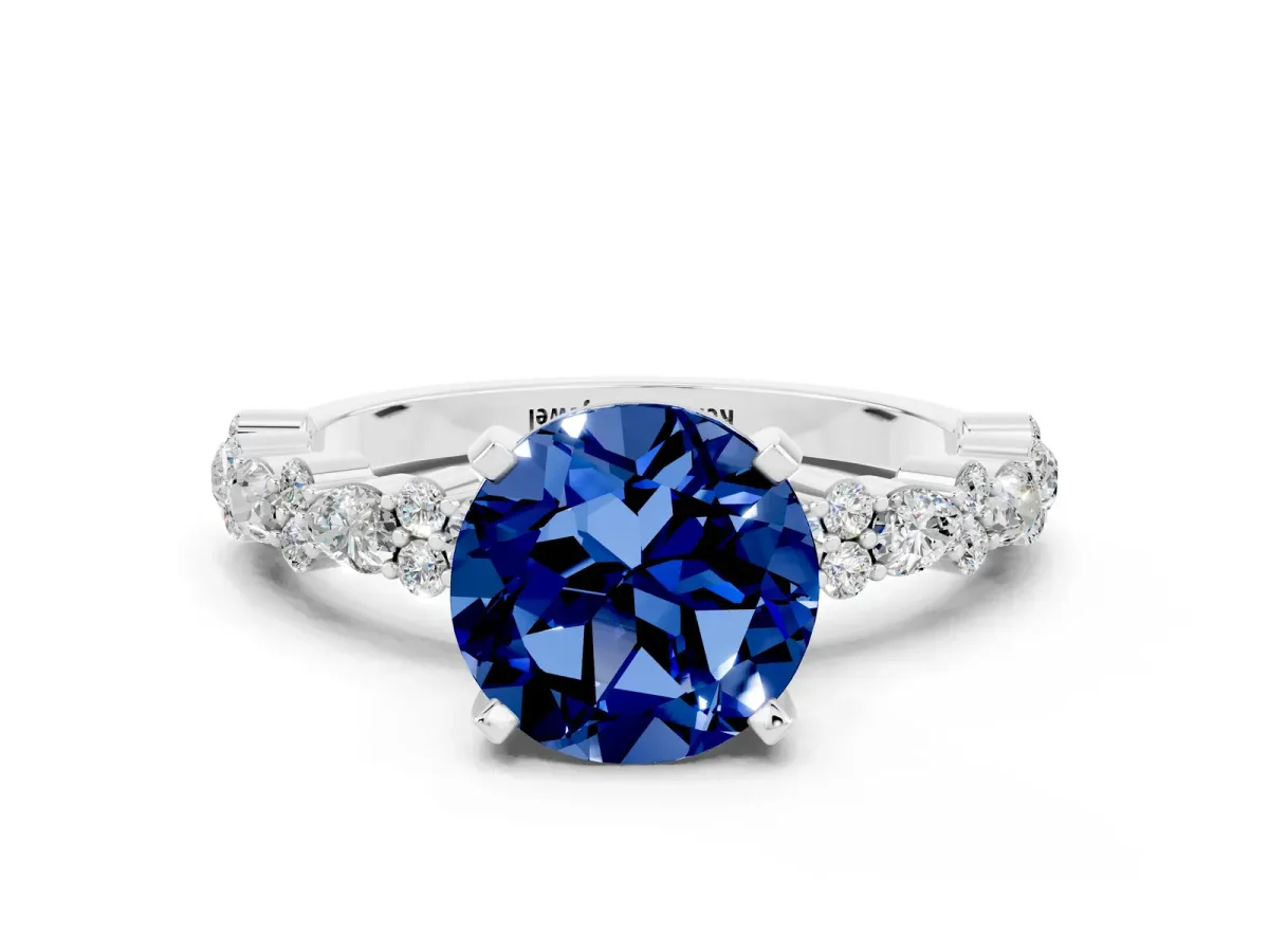 Round Cut Blue Sapphire Side Stone Solitaire Ring with Round and Four-Prong Setting White gold
