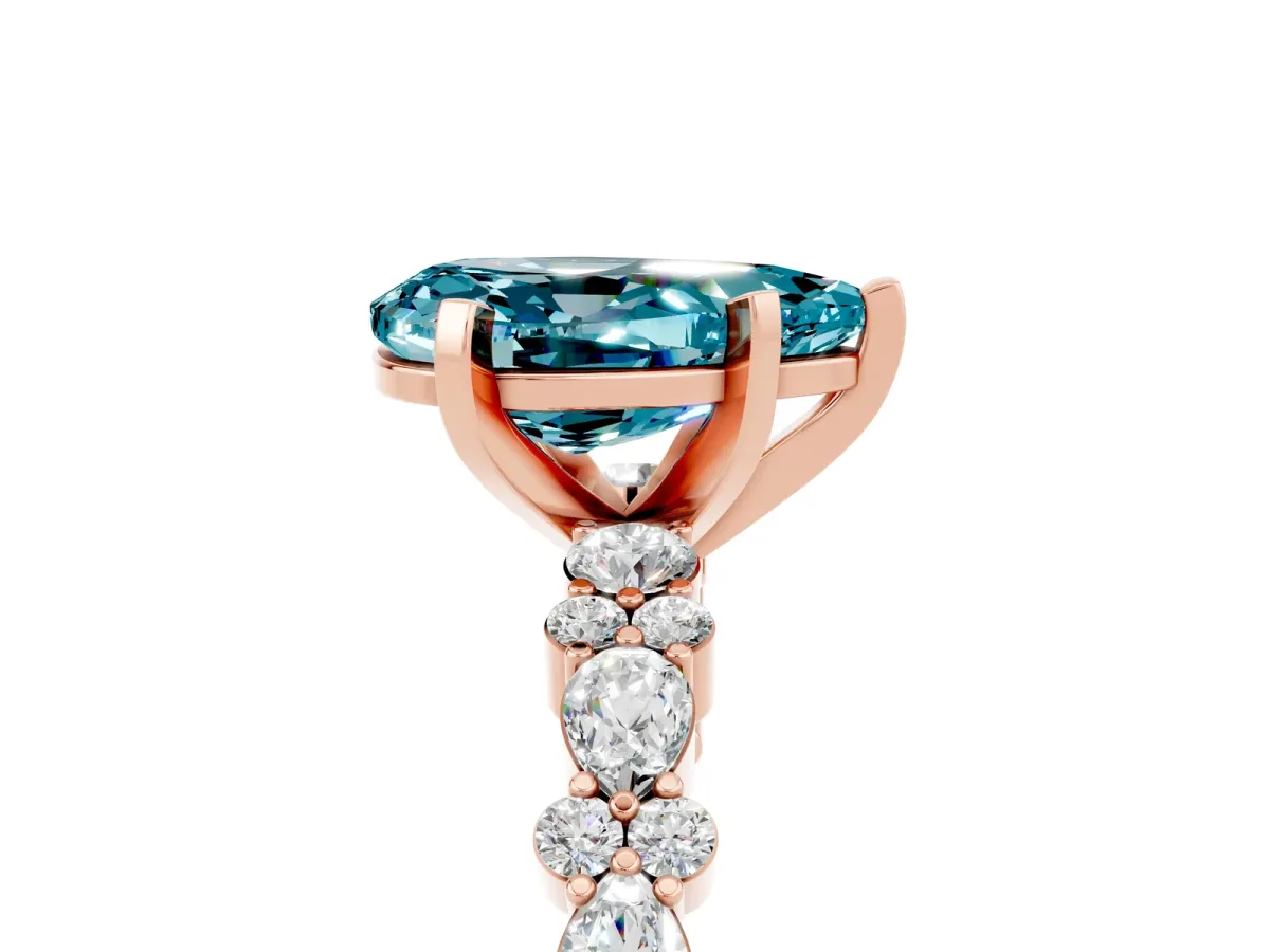 Pear Cut Blue Topaz Side Stone Solitaire Ring with Round and Four-Prong Setting Rose gold