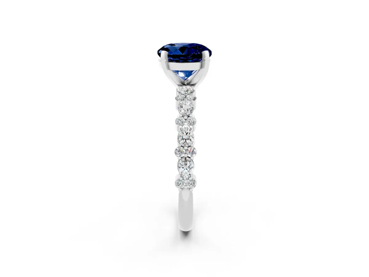 Round Cut Blue Sapphire Side Stone Solitaire Ring with Round and Four-Prong Setting White gold