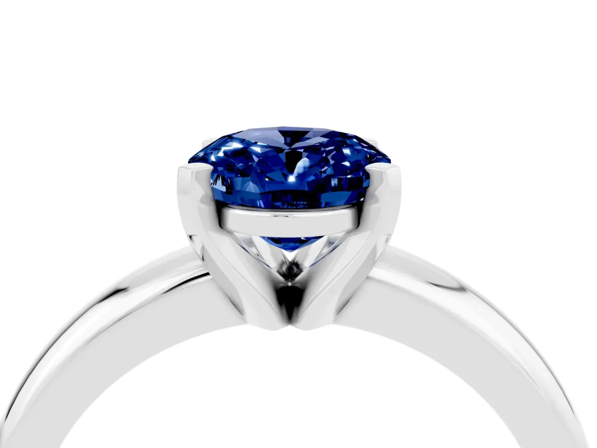 Oval Cut Blue Sapphire Solitaire Engagement Ring with Round Band and Four-Prong Setting Silver