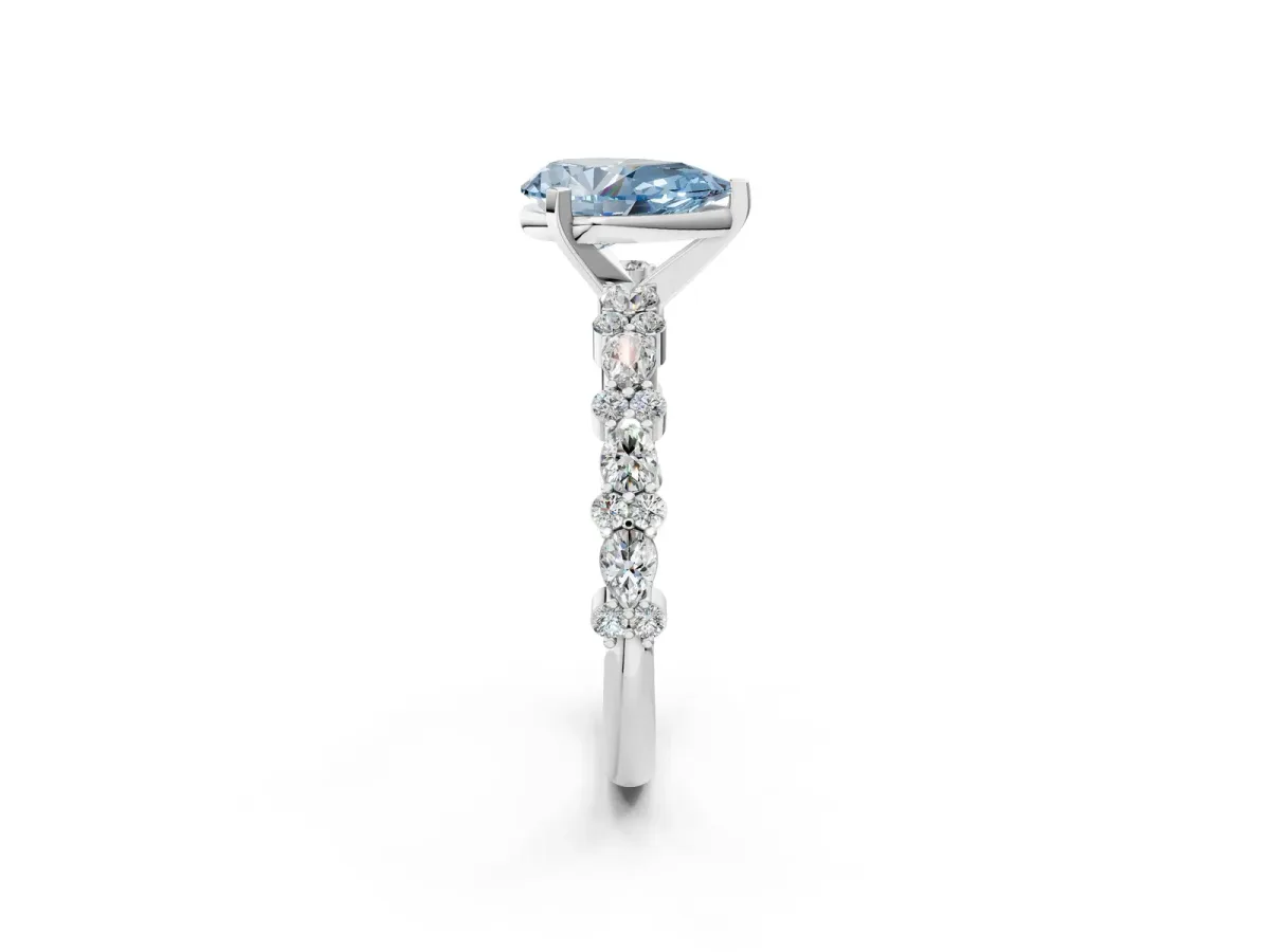 Fancy Blue Pear Cut Diamond Side Stone Solitaire Ring with Round and Four-Prong Setting Platinum