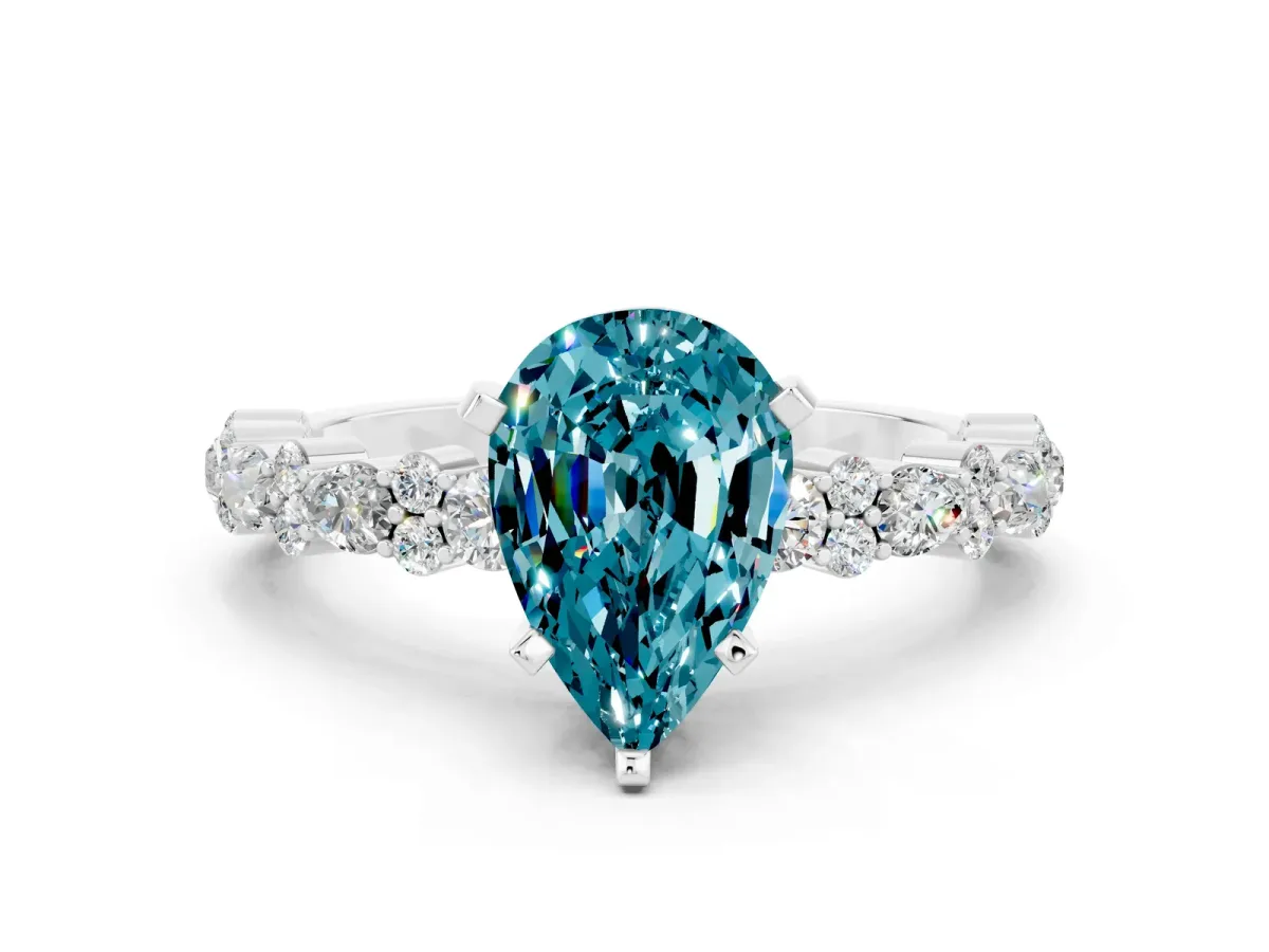 Pear Cut Blue Topaz Side Stone Solitaire Ring with Round and Four-Prong Setting White gold