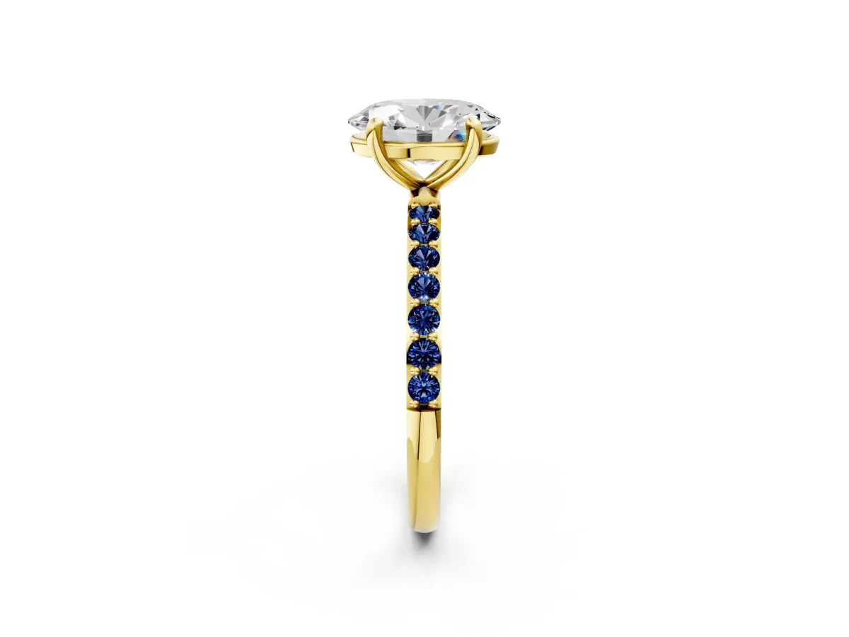 Oval Cut Diamond Solitaire Ring with Round Blue Sapphire Pavé Band and Prong Setting Yellow gold