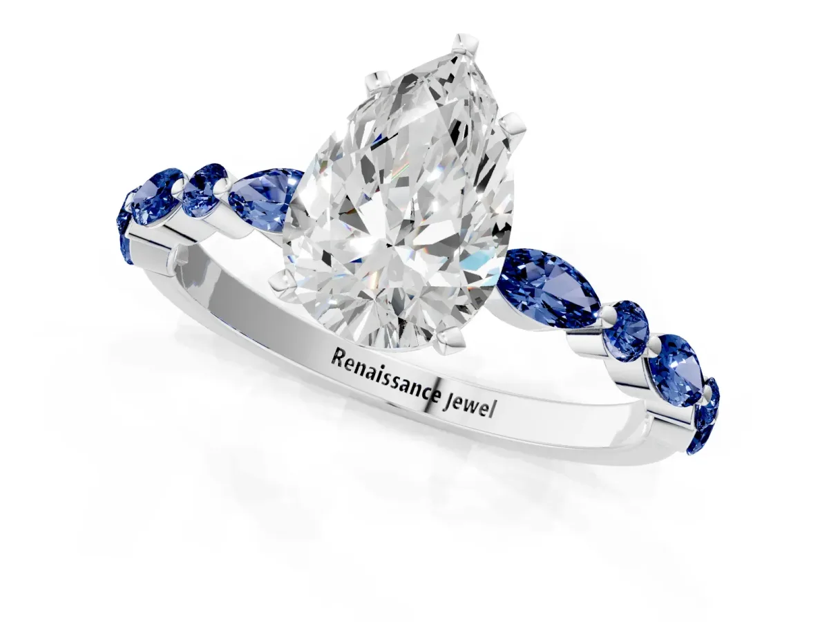 Pear Cut Diamond Ring with Marquise and Round Blue Sapphire Side Stones and Four-Prong Setting Platinum