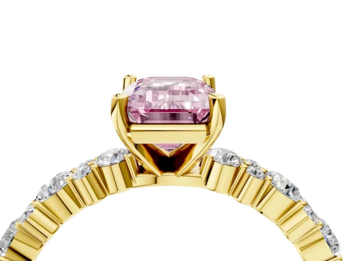 Fancy Pink Emerald Cut Diamond Side Stone Solitaire Ring with Round and Four-Prong Setting Yellow gold