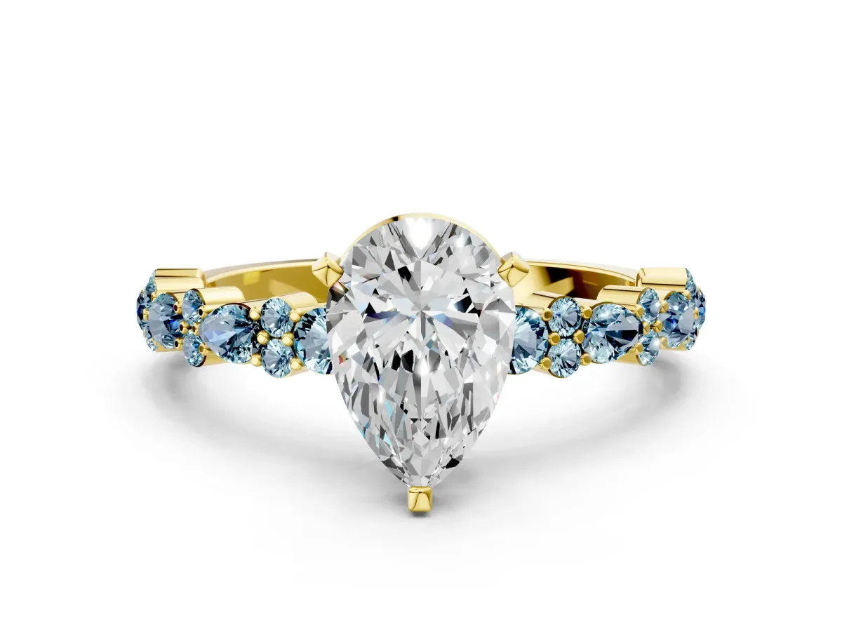 Pear Cut Diamond Side Stone Solitaire Ring with Round Aquamarine and Four-Prong Setting Yellow gold