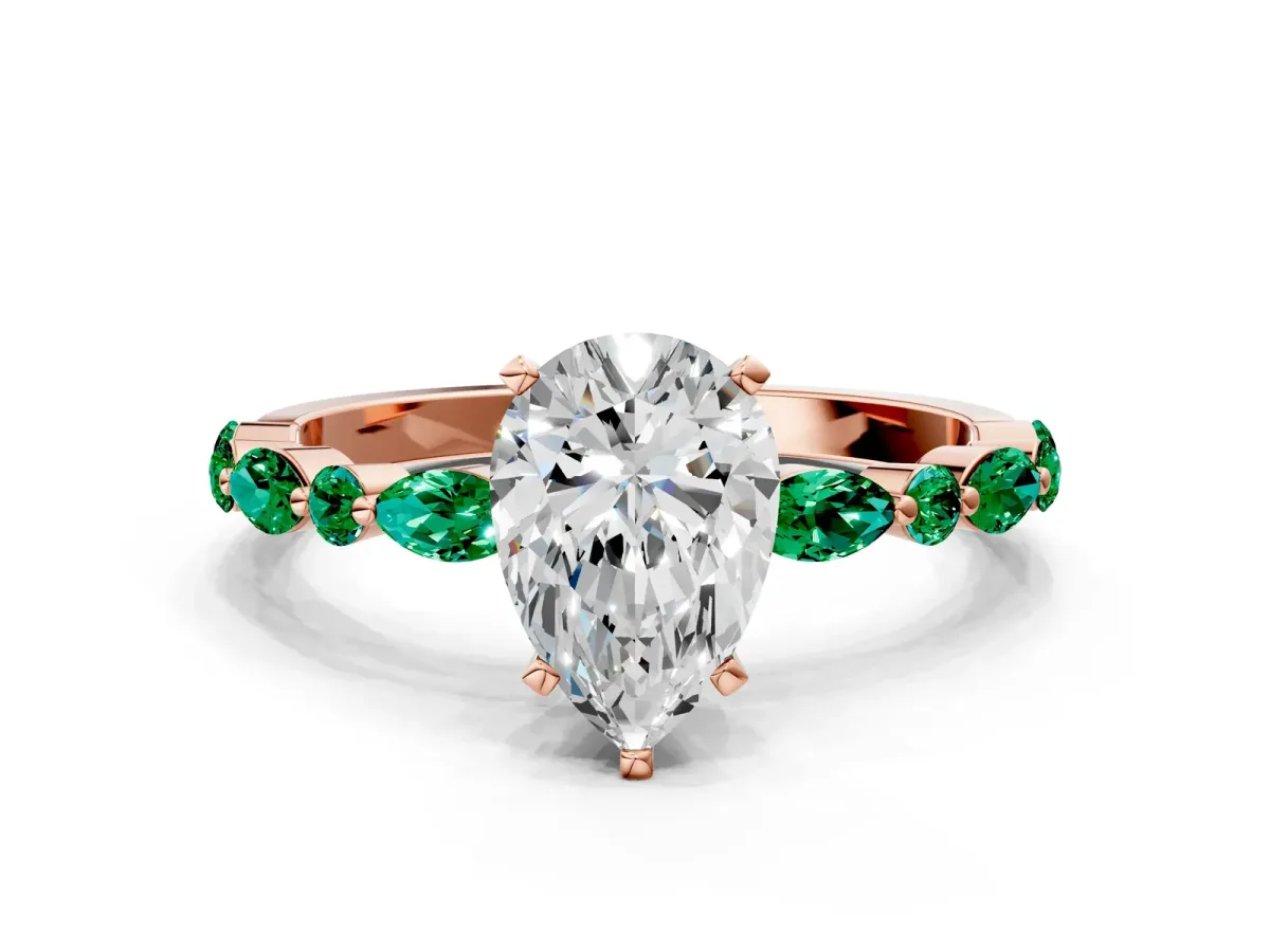 Pear Cut Diamond Ring with Marquise and Round Emerald Side Stones and Four-Prong Setting Rose gold