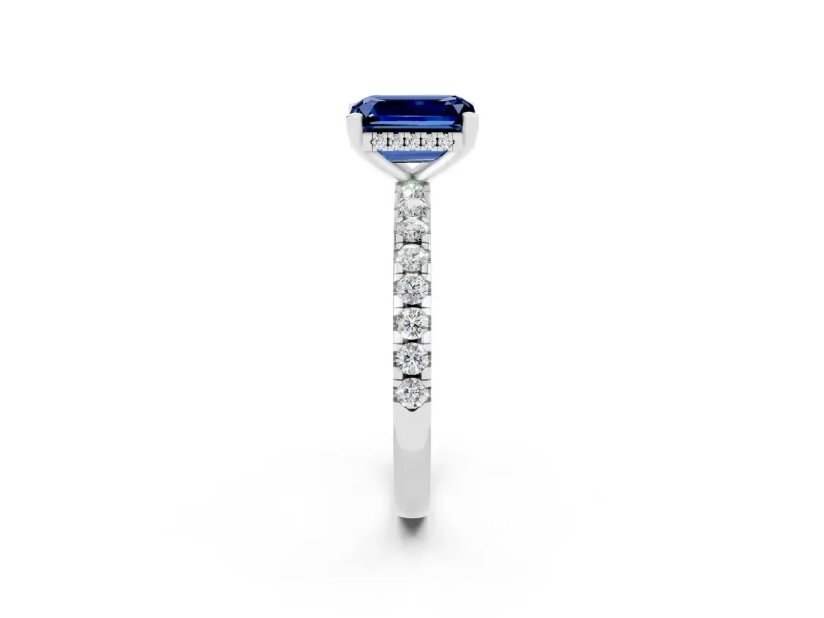 Emerald Cut Blue Sapphire Solitaire Ring with Round Pavé Band and Four-Prong Setting Silver