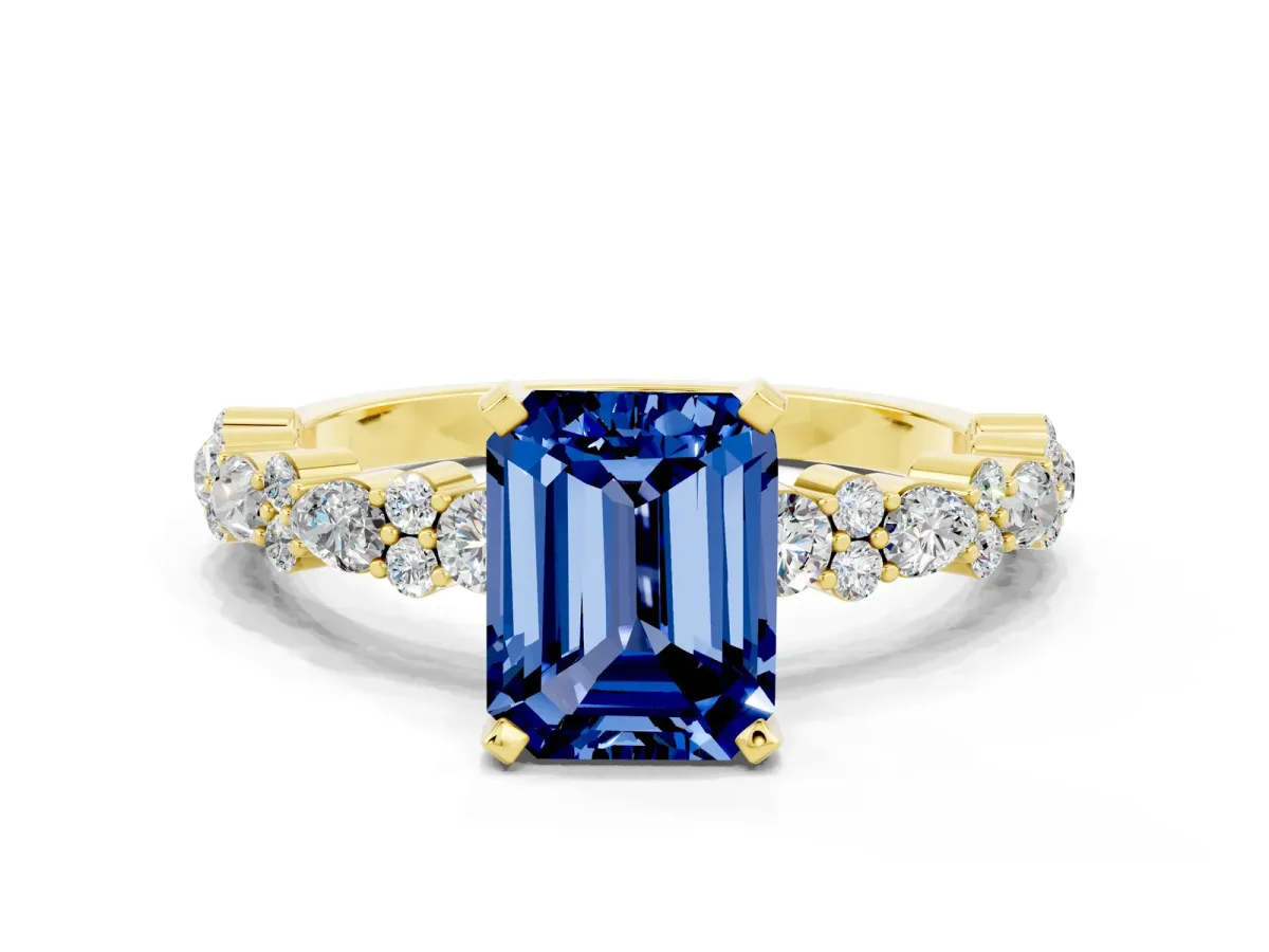 Emerald Cut Blue Sapphire Side Stone Solitaire Ring with Round and Four-Prong Setting Yellow gold