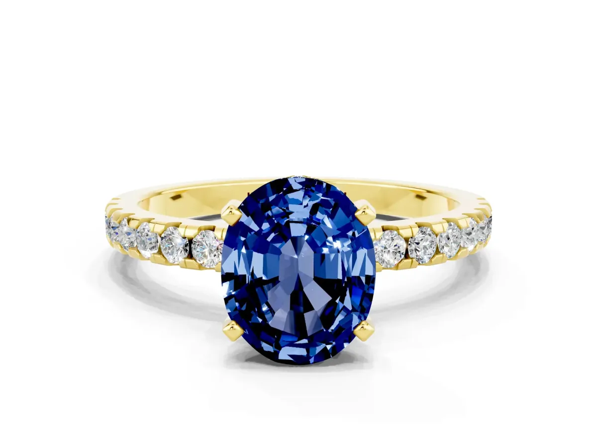 Oval Cut Blue Sapphire Solitaire Ring with Round Pavé Band and Four-Prong Setting Yellow gold
