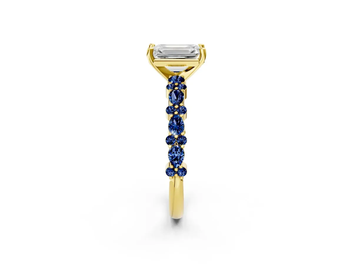 Emerald Cut Diamond Side Stone Solitaire Ring with Round Blue Sapphire and Four-Prong Setting Yellow gold