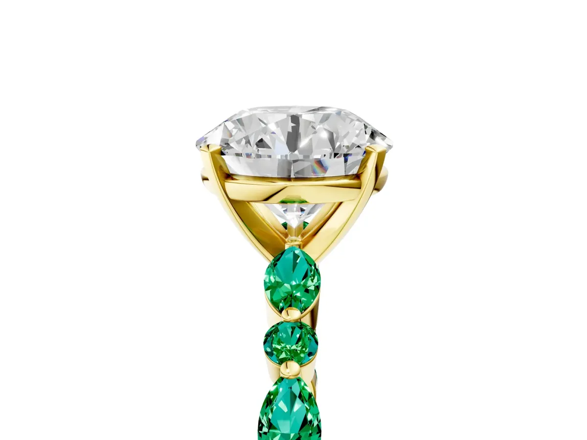 Round Cut Diamond Ring with Marquise and Round Emerald Side Stones and Four-Prong Setting Yellow gold