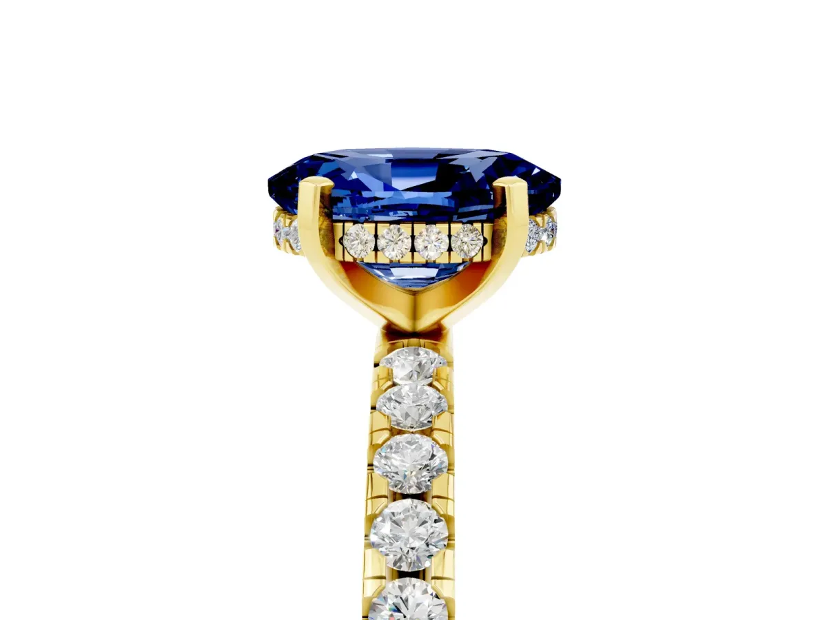 Oval Cut Blue Sapphire Solitaire Ring with Round Pavé Band and Four-Prong Setting Yellow gold