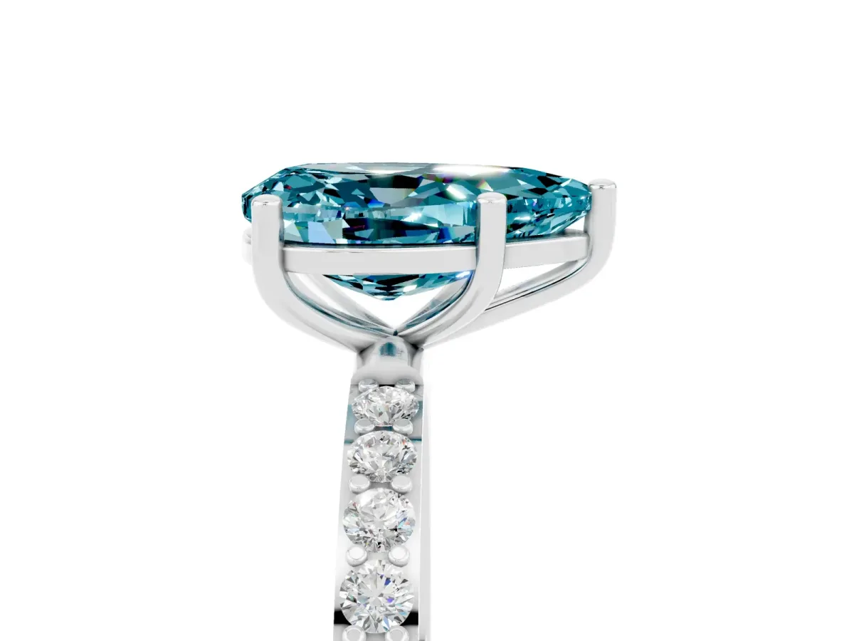 Pear Cut Blue Topaz Solitaire Ring with Round Pavé Band and Prong Setting Silver
