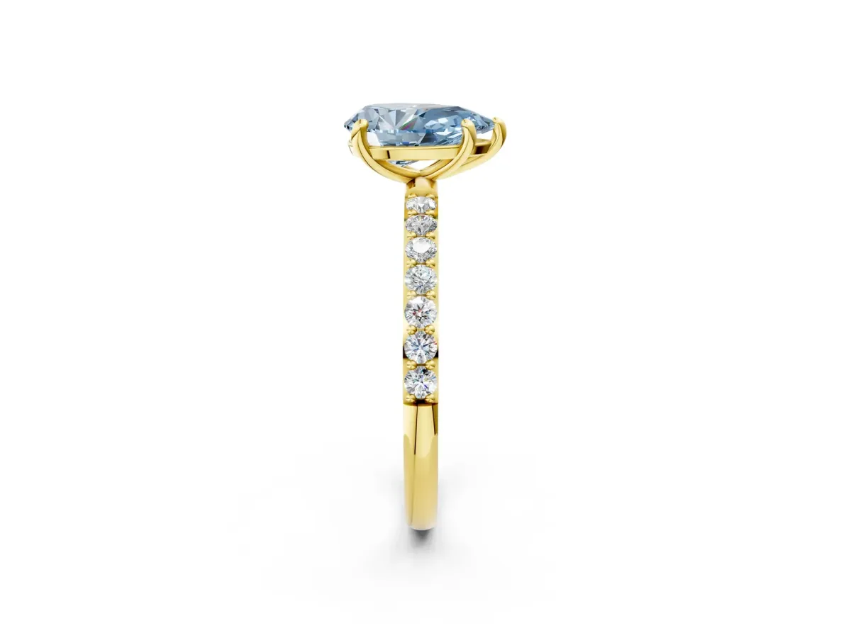 Fancy Blue Pear Cut Diamond Solitaire Ring with Round Pavé Band and Prong Setting Yellow gold