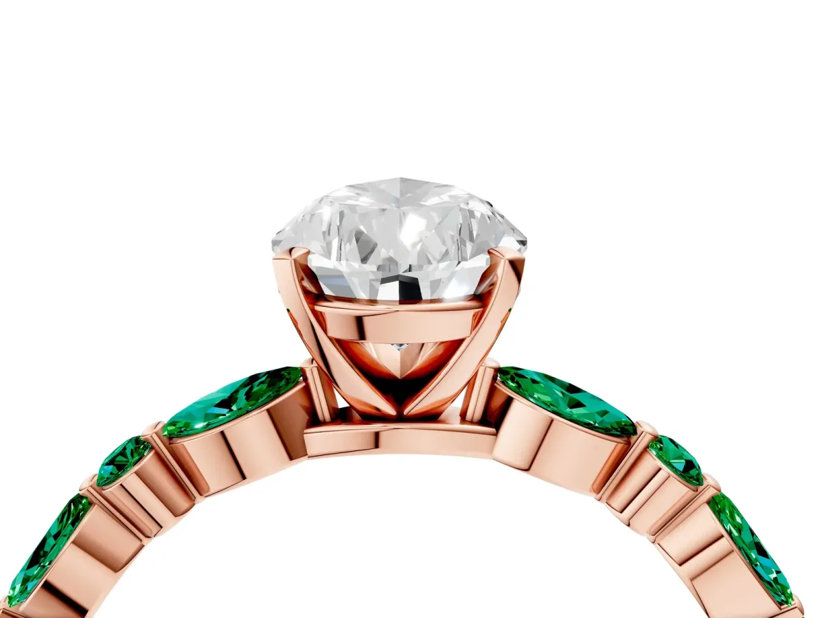 Pear Cut Diamond Ring with Marquise and Round Emerald Side Stones and Four-Prong Setting Rose gold