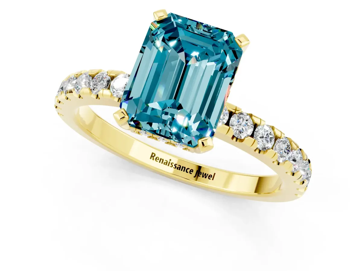 Emerald Cut Blue Topaz Solitaire Ring with Round Pavé Band and Four-Prong Setting Yellow gold