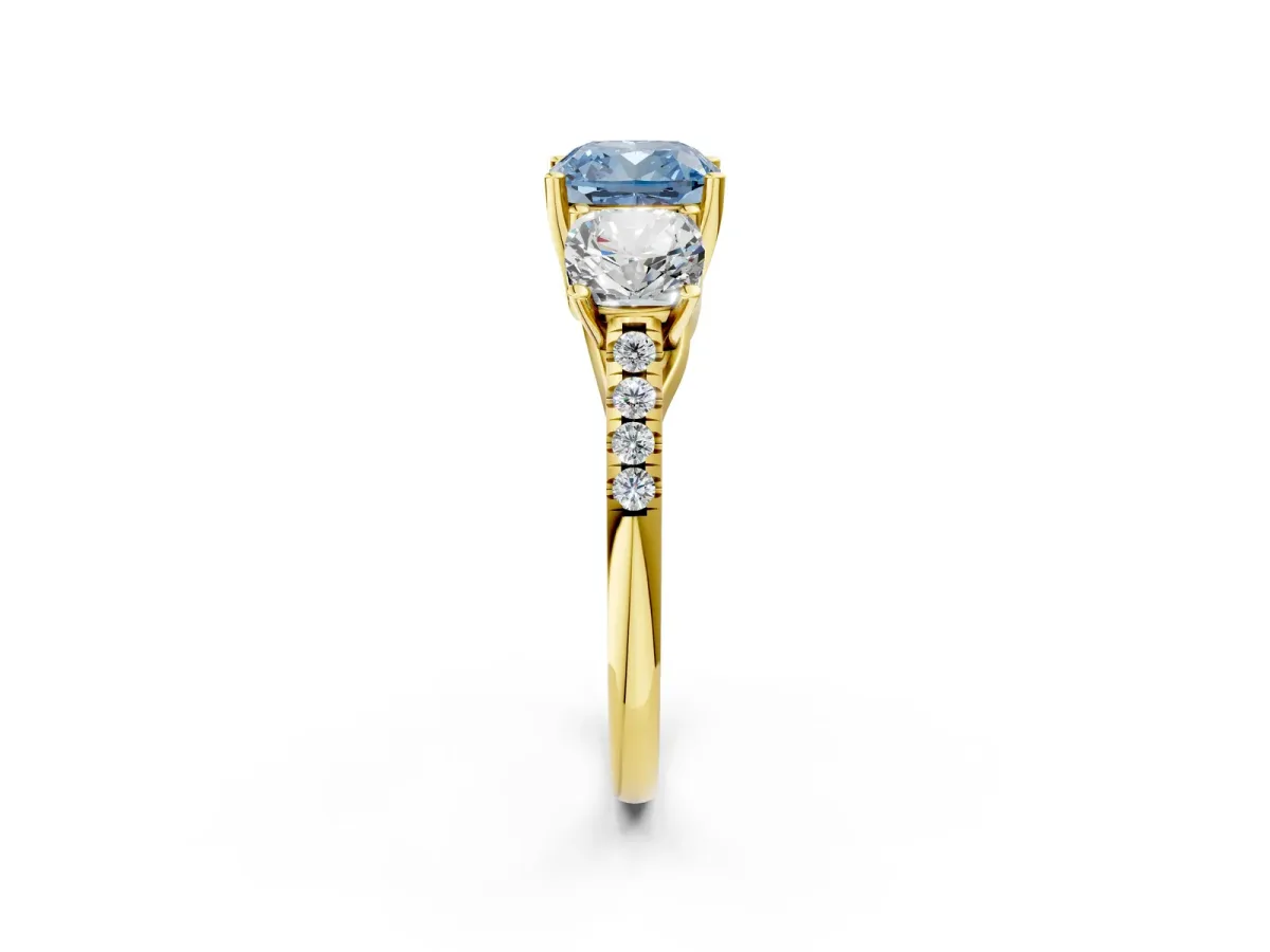 Fancy Blue Three-Stone Cushion Cut Diamond Ring with Round Pavé Band and Prong Setting Yellow gold