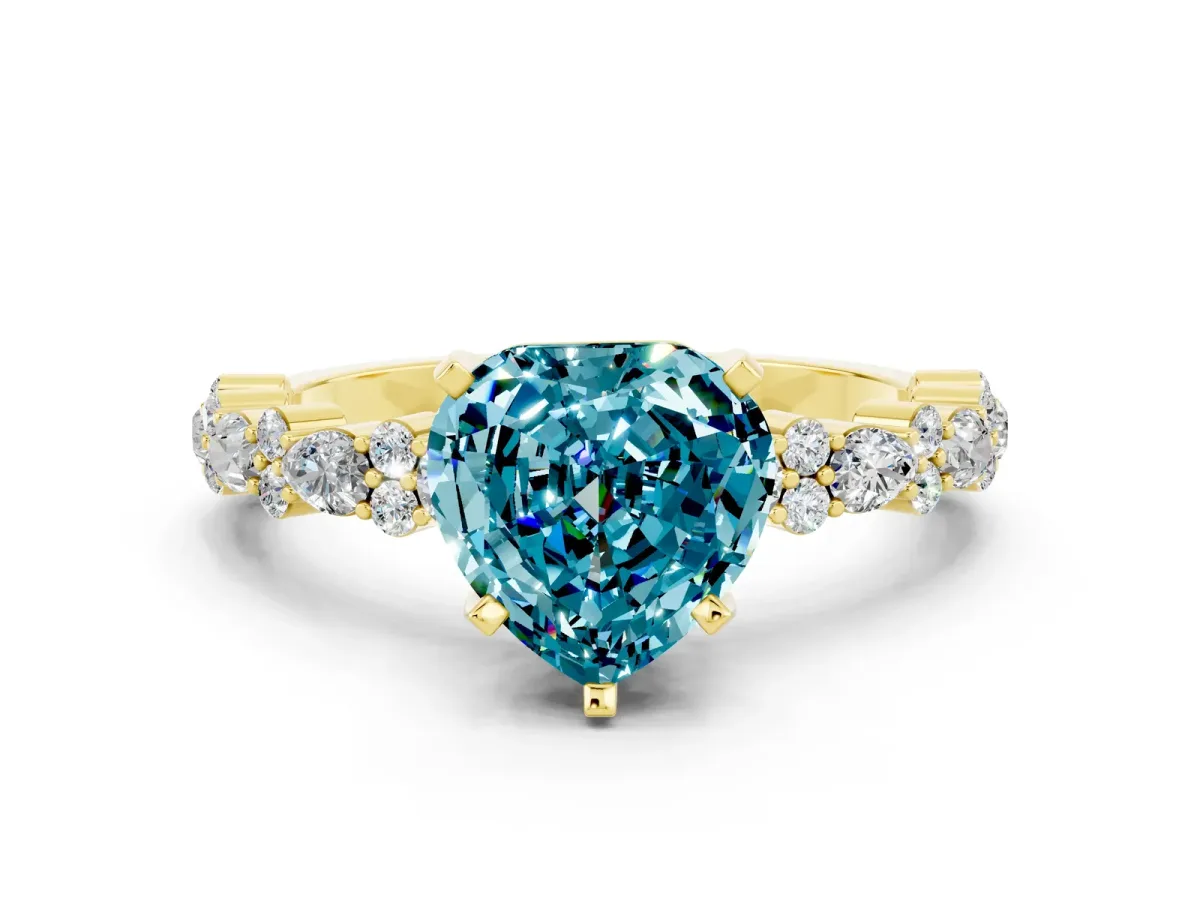 Heart Cut Blue Topaz Side Stone Solitaire Ring with Round and Four-Prong Setting Yellow gold
