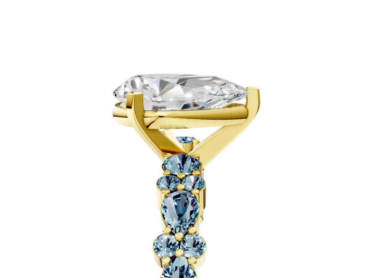 Pear Cut Diamond Side Stone Solitaire Ring with Round Aquamarine and Four-Prong Setting Yellow gold