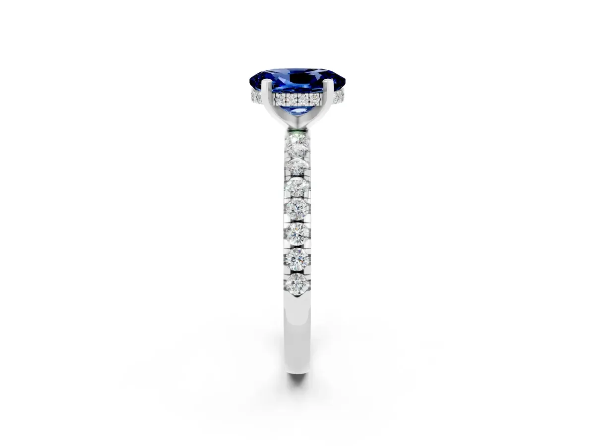 Oval Cut Blue Sapphire Solitaire Ring with Round Pavé Band and Four-Prong Setting Silver