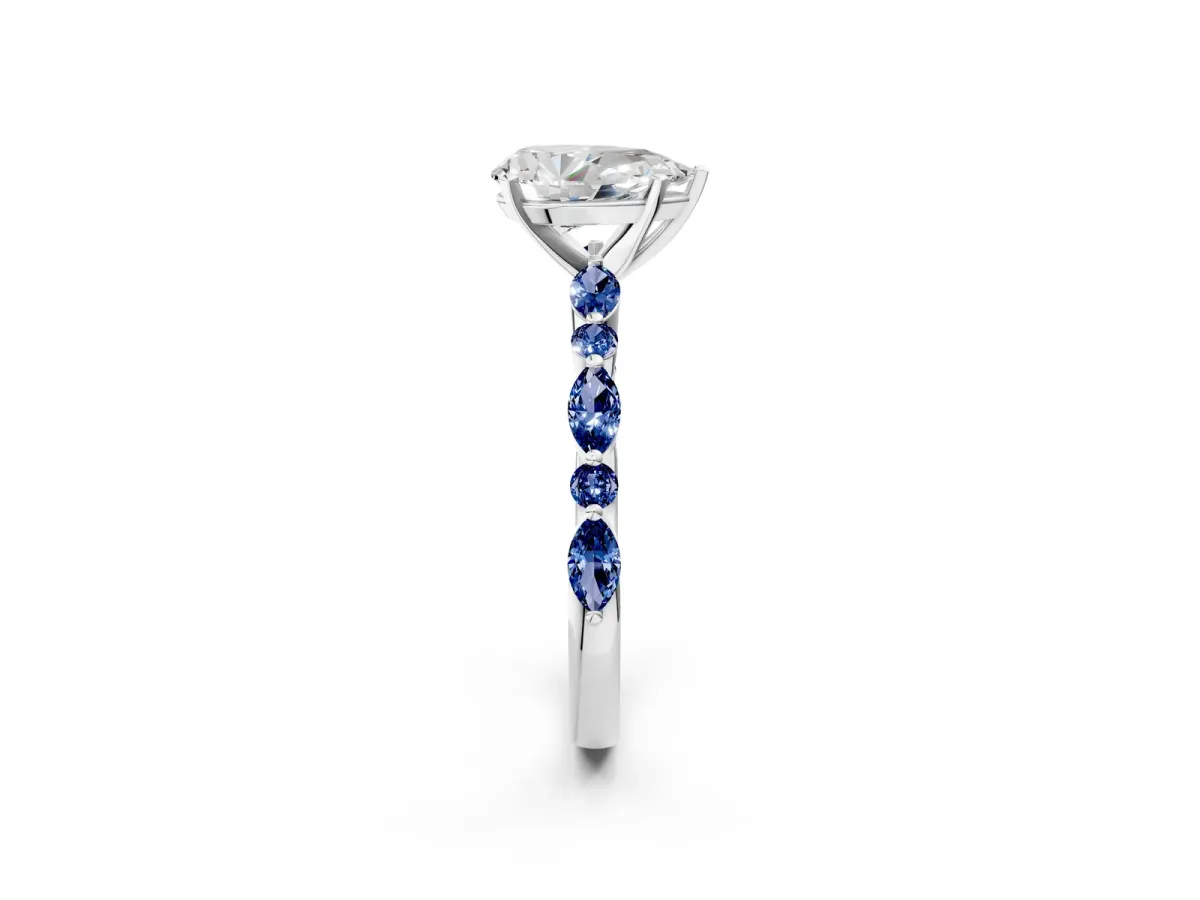 Pear Cut Diamond Ring with Marquise and Round Blue Sapphire Side Stones and Four-Prong Setting Platinum