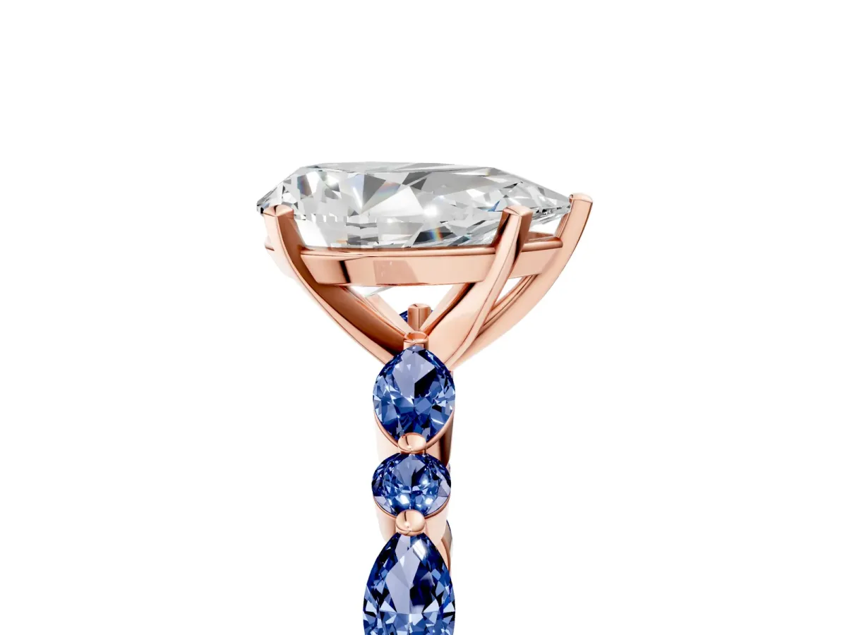 Pear Cut Diamond Ring with Marquise and Round Blue Sapphire Side Stones and Four-Prong Setting Rose gold
