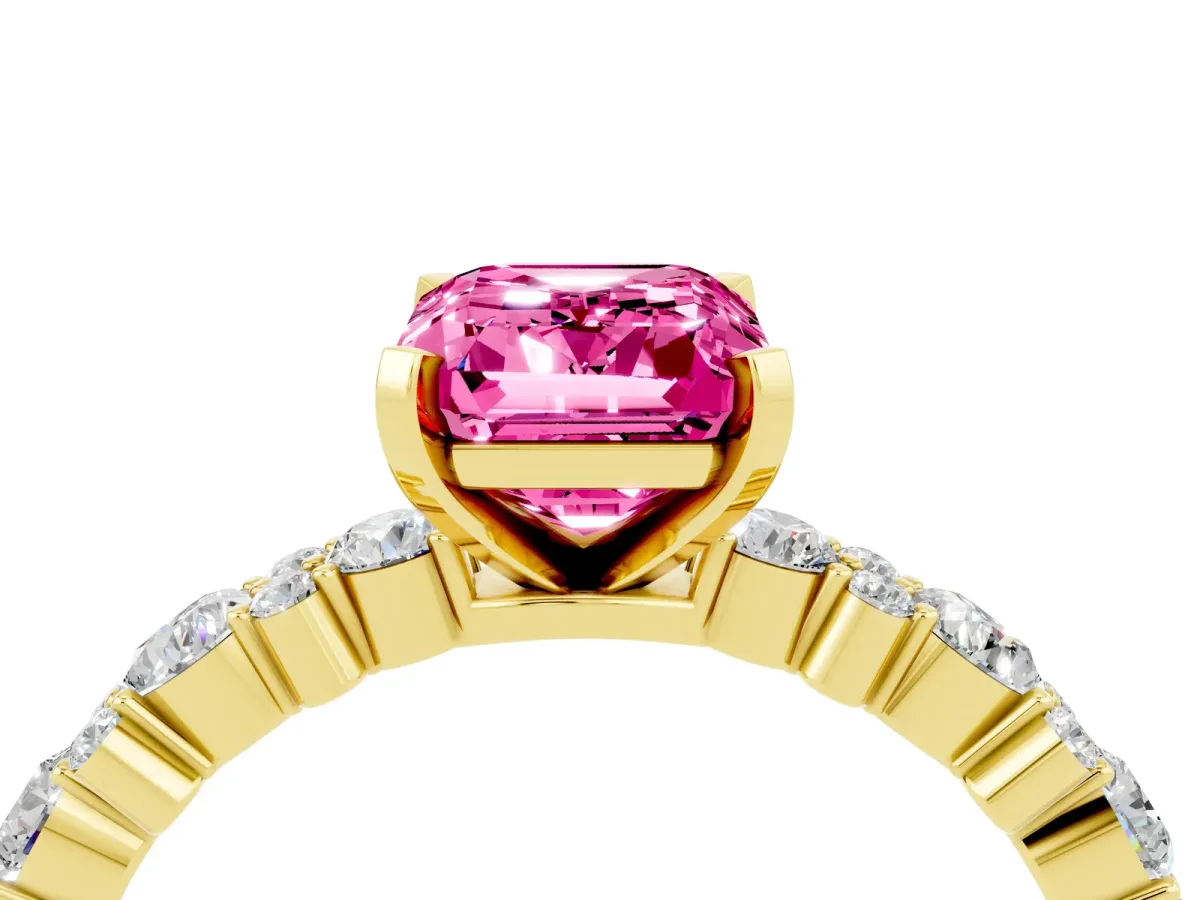 Emerald Cut Pink Sapphire Side Stone Solitaire Ring with Round and Four-Prong Setting Yellow gold