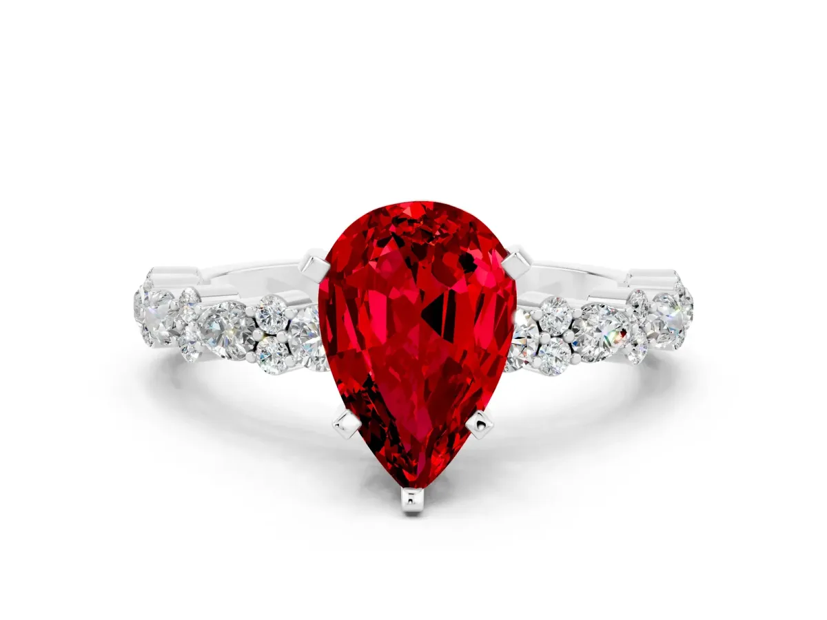 Pear Cut Ruby Side Stone Solitaire Ring with Round and Four-Prong Setting White gold