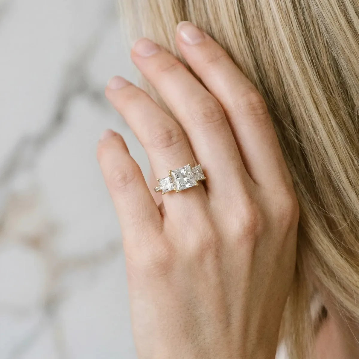 Three-Stone Princess Cut Diamond Ring with Round Pavé Band and Prong Setting Yellow gold