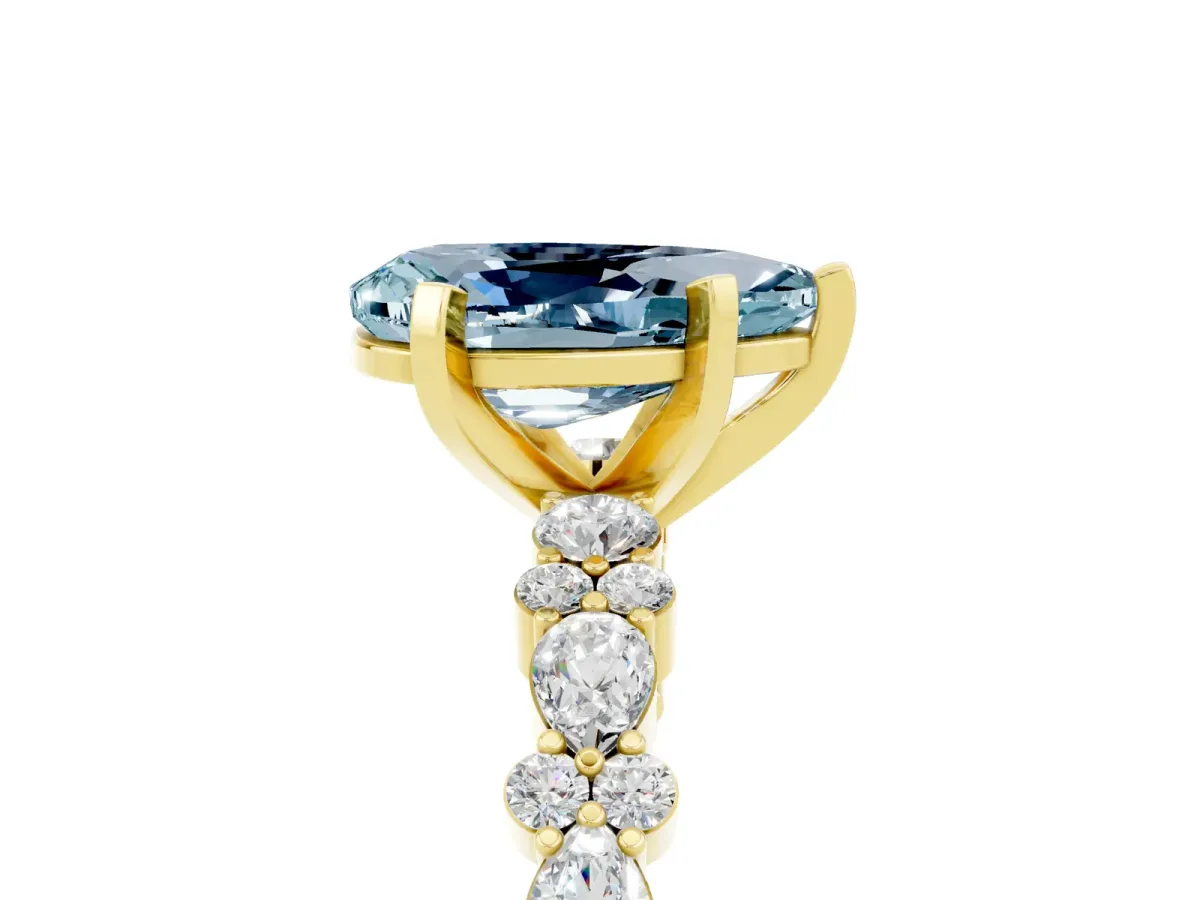 Pear Cut Aquamarine Side Stone Solitaire Ring with Round and Four-Prong Setting Yellow gold