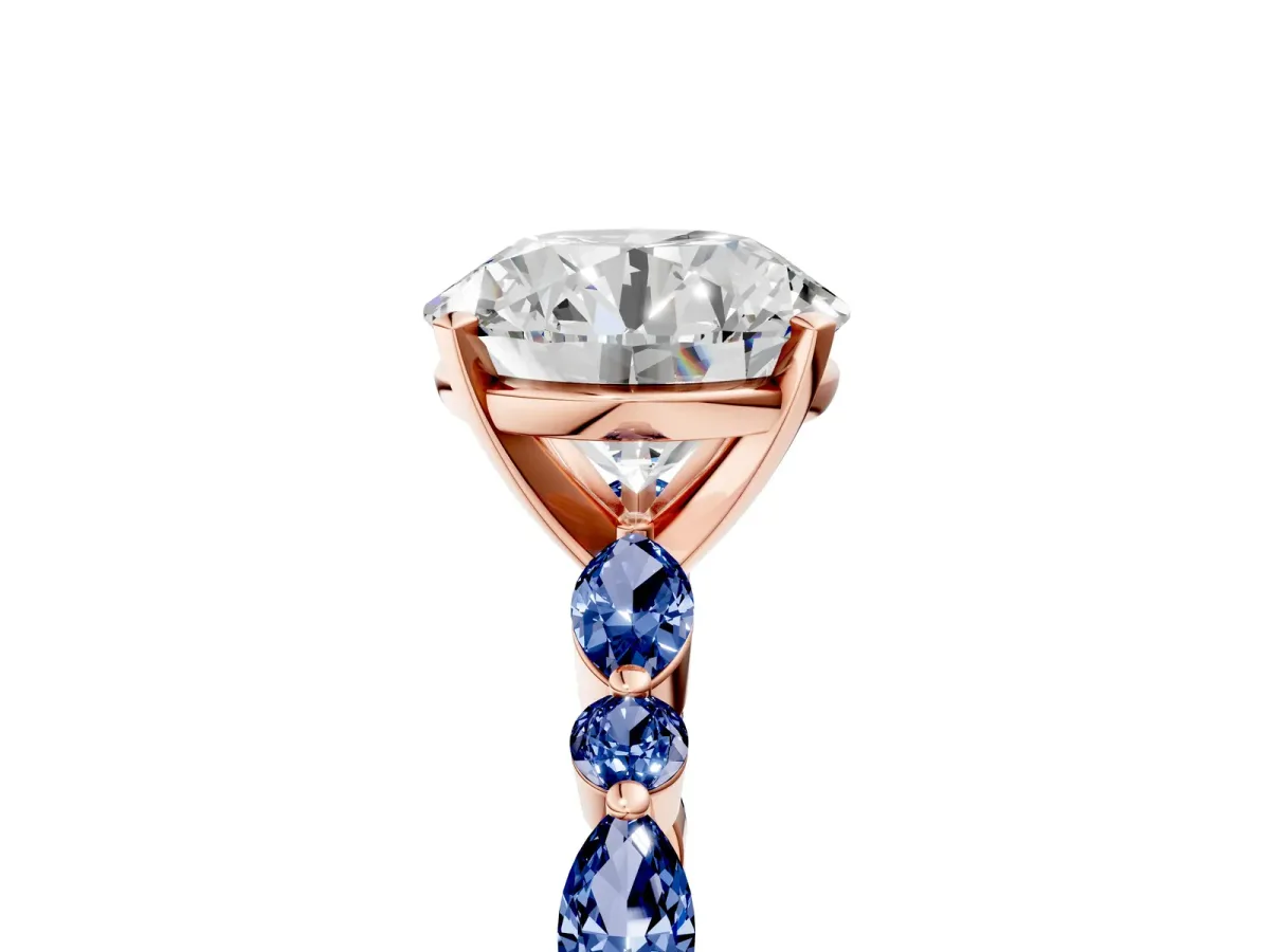 Round Cut Diamond Ring with Marquise and Round Blue Sapphire Side Stones and Four-Prong Setting Rose gold
