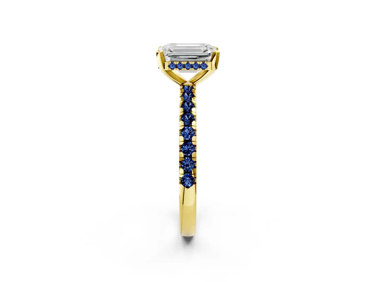 Emerald Cut Diamond Solitaire Ring with Round Blue Sapphire Pavé Band and Four-Prong Setting Yellow gold