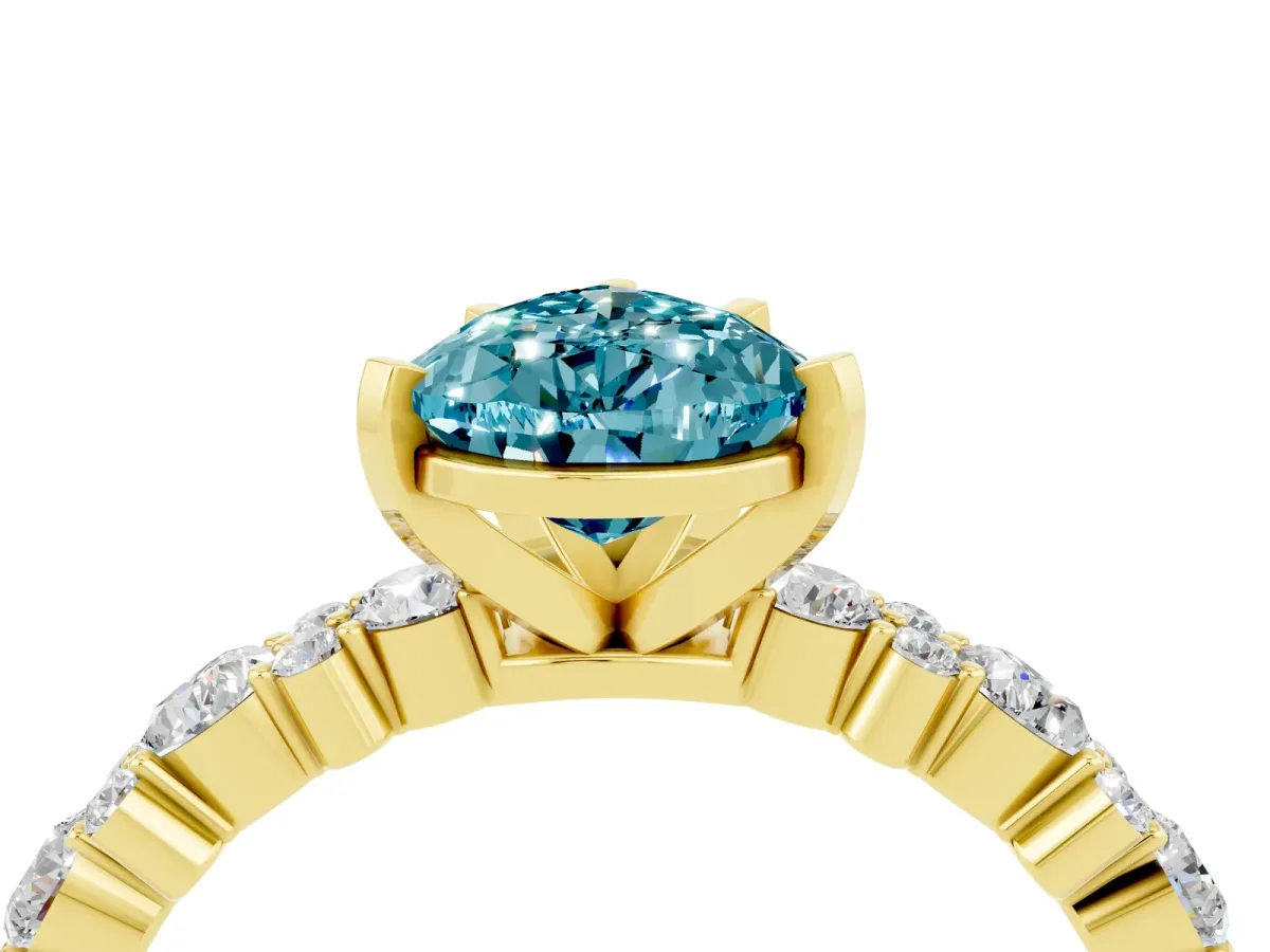 Pear Cut Blue Topaz Side Stone Solitaire Ring with Round and Four-Prong Setting Yellow gold