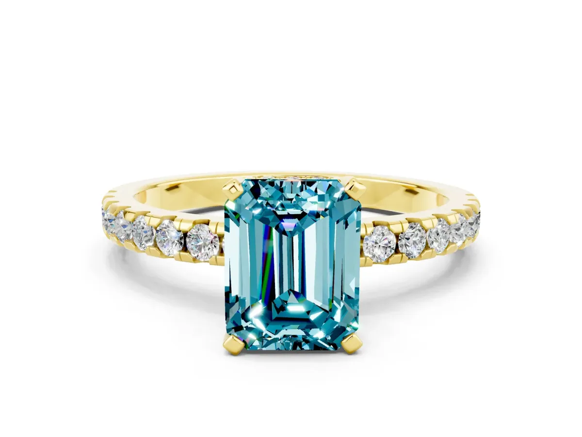 Emerald Cut Blue Topaz Solitaire Ring with Round Pavé Band and Four-Prong Setting Yellow gold